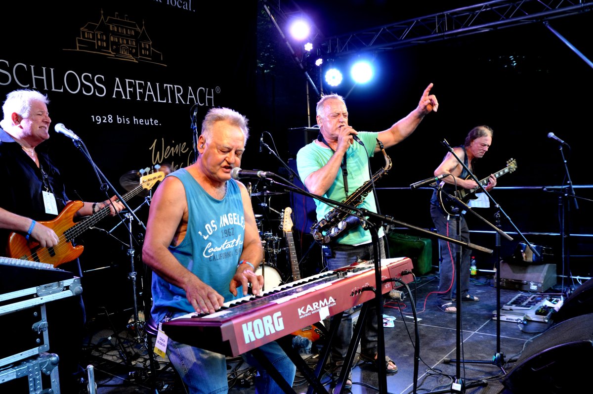 Grachmusikoff live auf der Bühne im Jahr 2017: Keyboarder im blauen Shirt, Saxofonist im grünen Shirt und Gitarrist